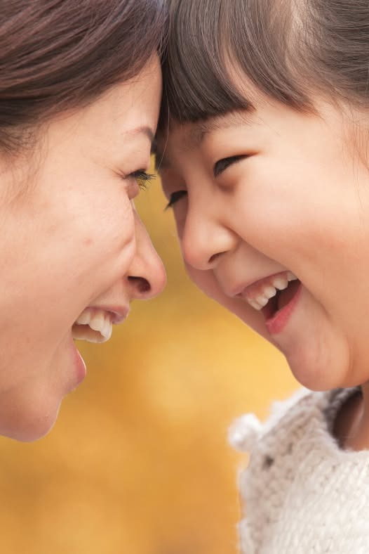 Mother and daughter smiling